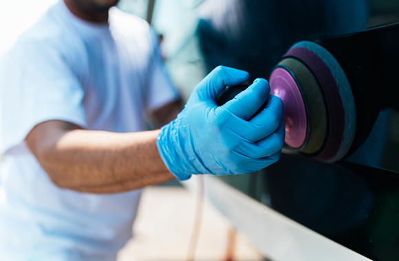 Man with glove doing Boat Detailing in Palm Beach Shores, North Palm Beach, Pompano Beach, and Surrounding Areas