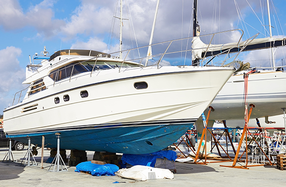 a boat lifted up undergoing Boat Painting in North Palm Beach, Pompano Beach, North Miami Beach, Fort Lauderdale, Palm Beach Shores, Hallandale