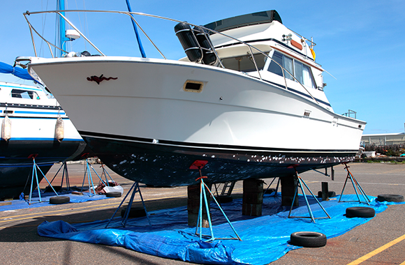 a boat lifted receiving Fiberglass Boat Repair in Pompano Beach, North Miami Beach, Palm Beach Shores, Key Biscayne, Hollywood, Virginia Key